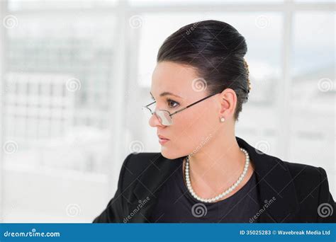 elegant businesswoman in eyeglasses looking away stock image image of