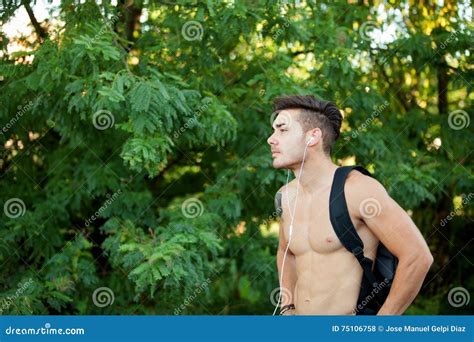Handsome Shirtless Man Doing Hiking While Listening To Music Stock