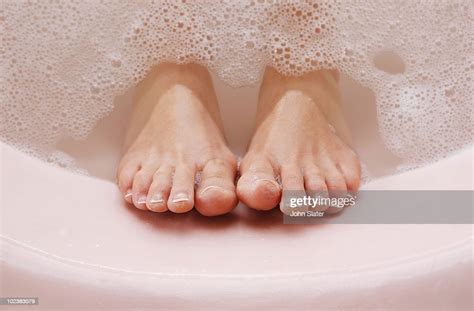 Womans Feet Resting Against Bath Tub With Bubbles Photo Getty Images