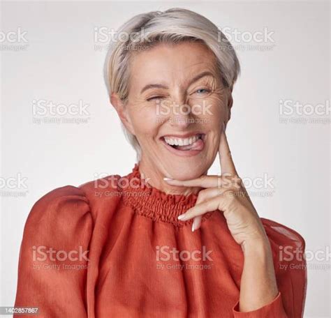 Portrait Of One Quirky Playful Mature Caucasian Woman Isolated Against