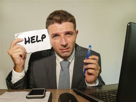 Frustrated Businessman Desperate At Office Computer Desk Holding