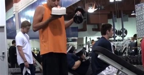 guy eats junk food at gym while working out