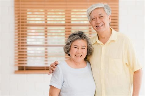 Free Photo Asian Elderly Couple Feeling Happy Smiling And Looking To