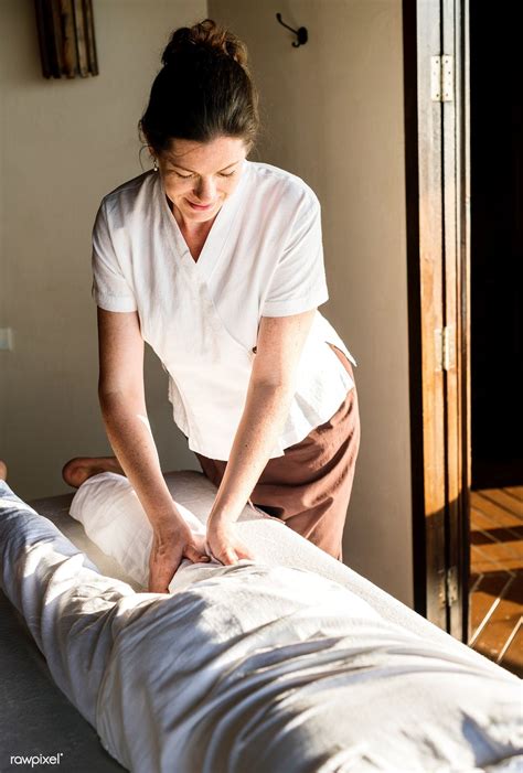Female Massage Therapist Giving A Massage At A Spa Premium Image By