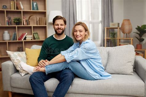 romantic couple embracing sofa happy couple relaxing on couch at home
