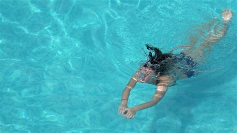 woman swimming underwater in slow motion stock footage