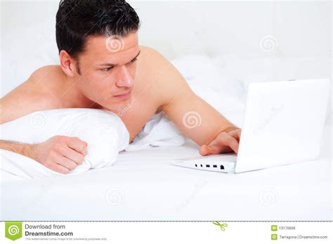 Bed Lying Person With Computer Royalty Free Stock Images