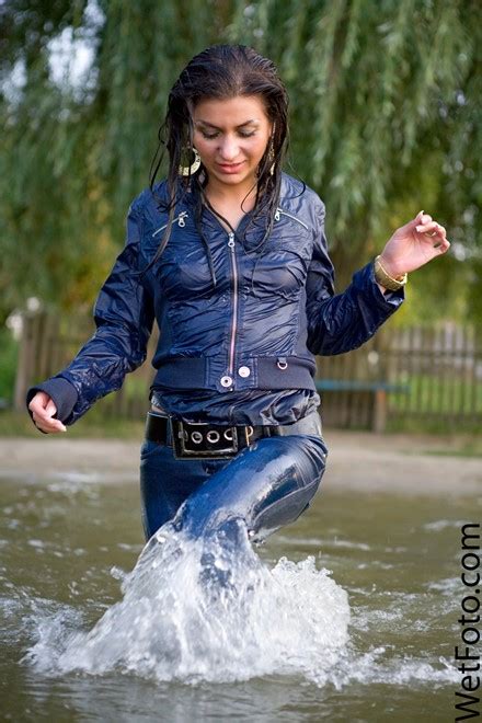 wetlook by beautiful girl in jacket tight jeans on shoes with heels by