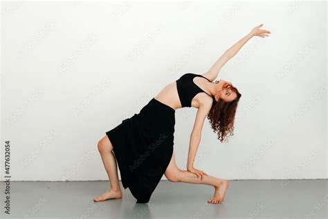 Young Redhead Woman Dancer Performing Dance Move Leaning On Her Led