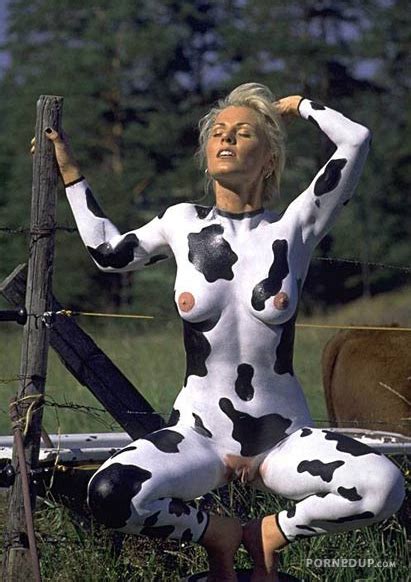 woman in cow makeup sitting naked by fence porned up