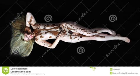 The Girl Covered With Hot Chocolate Lies On A Black Background Stock