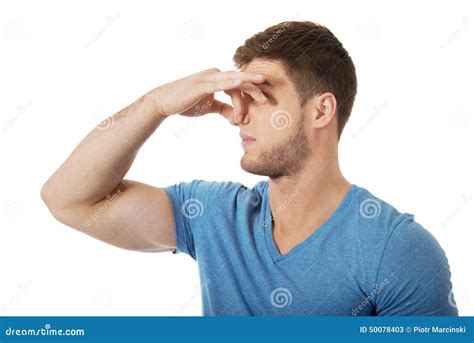 young man pinching  nose stock photo image