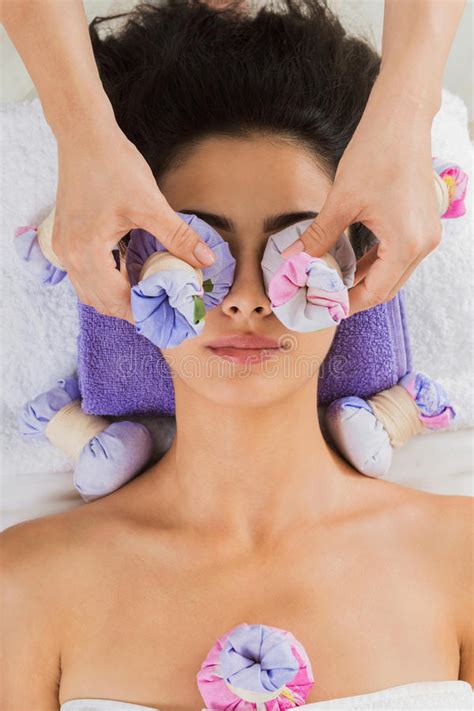 woman massagist make face lifting massage in spa wellness center stock