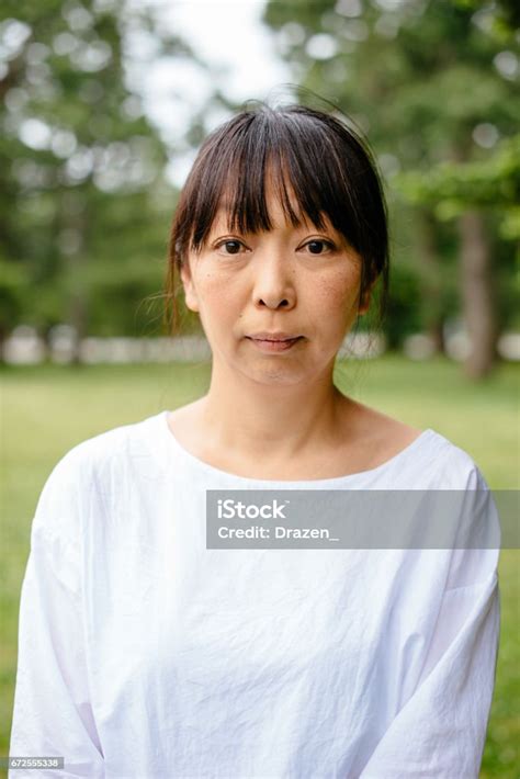 beautiful japanese woman spending afternoon in park breathing fresh