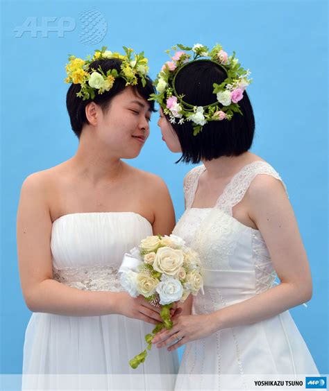 japan tokyo a lesbian couple kiss as they pose for photos taken by a wedding photo service