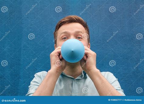 man blowing   balloon stock image image  enjoyment