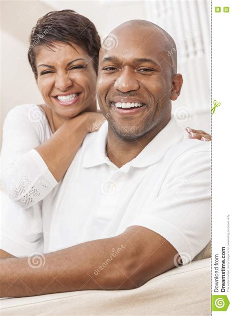 Happy African American Woman Couple Sitting At Home Stock