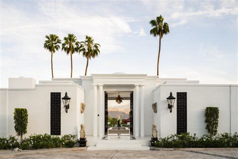 white house  black shutters  palm trees   front door