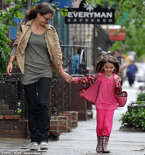 katie holmes takes her daughter for a swim in the lake after chugging