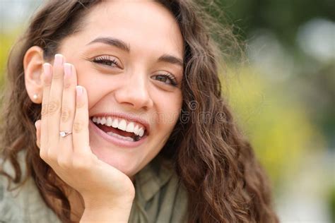 happy woman smiling at camera showing engagement ring stock image