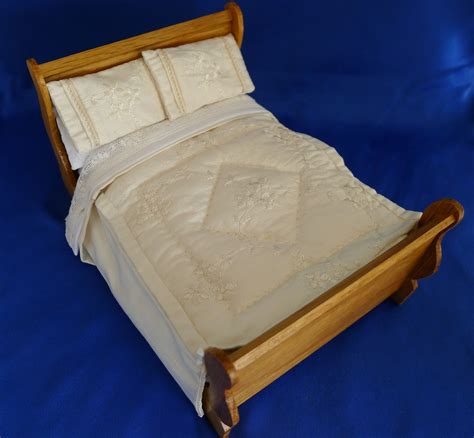 wooden bed frame   pillows  top     blue sheet