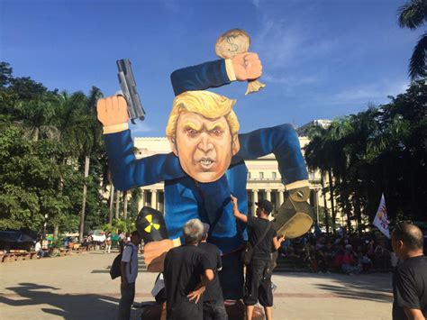 activists  burn trump effigy  day   asean summit