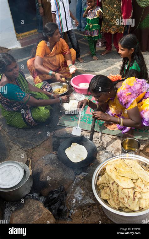 indian women  girls making sweet jaggery filled chapathi  dasara