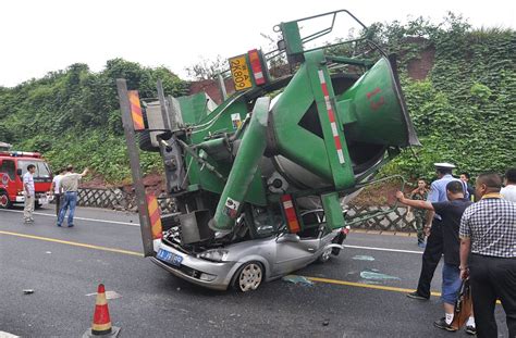 crash  china sees car flattened   cement mixer  driver  passenger survive daily mail