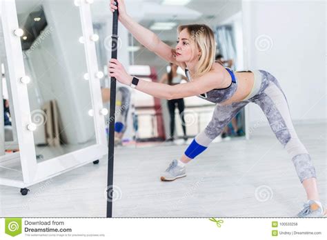 Attractive Blonde Sportswoman Doing Stretching Exercise Standing Feet