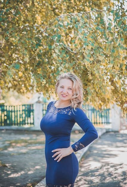 Premium Photo Beautiful Slim Blonde With A Long Blue Dress Smiles