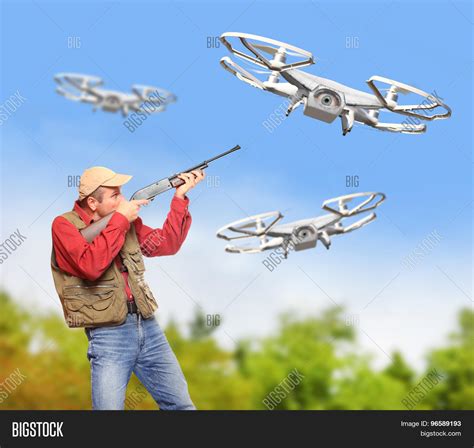 man shotgun shooting  drone image photo bigstock