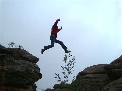 images man person adventure jump jumping rock climbing leap gap extreme sport