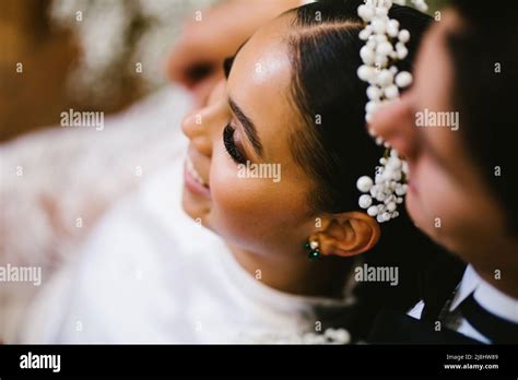 Latina Bride And Multiracial Groom Snuggle After The Wedding Ceremony