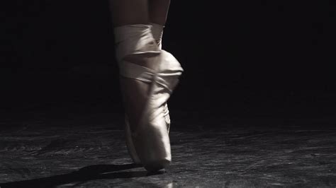 slow motion close up shot of a ballet dancers feet as she practices in