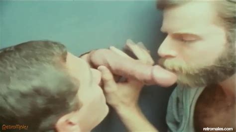Retro Males Two Guys Suck On A Hard Dick Through The Glory