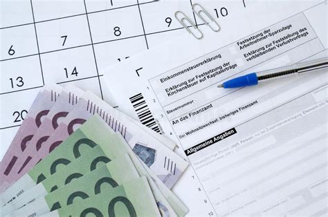 german tax form with pen and european money bills lies on office