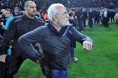 chairman takes gun onto the pitch shock pictures of paok owner marching to confront ref daily