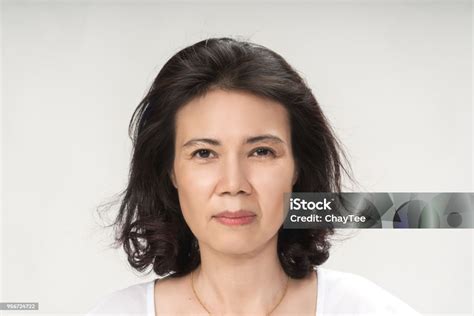 Portrait Of Beautiful Mature Asian Woman With Curly Hair Style Smiling