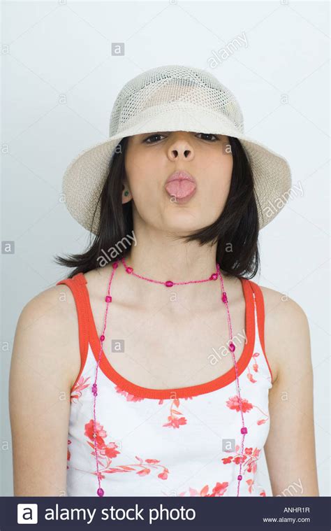 teenage girl sticking tongue out high resolution stock