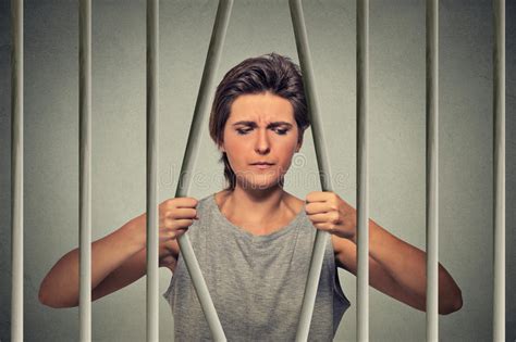 stressed desperate sad woman bending bars of her prison cell stock image image of jail free