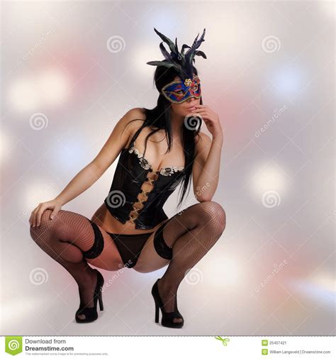 kinky woman with venetian mask and lingerie stock image
