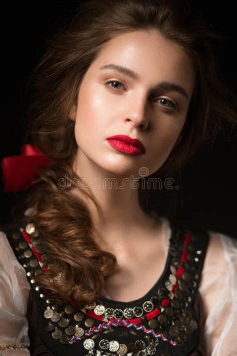 beautiful russian girl in national dress with a braid hairstyle and red lips beauty face stock