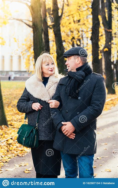 Happy Blonde Mature Woman And Handsome Middle Aged