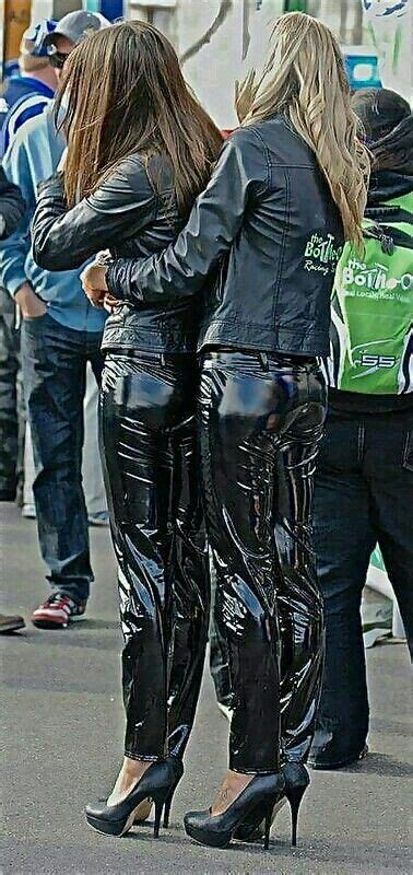 promo girls embracing in black pvc pants and jackets leather jeans