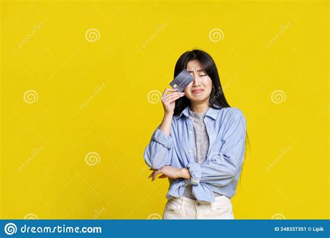 Crying Unhappy Asian Girl Holding Dark Credit Debit Card Touching Her