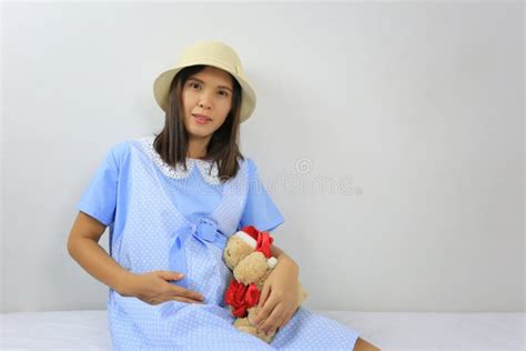 Asian Pregnant Women In Fashion Shoot Portrait Of Wearing Brown Stock