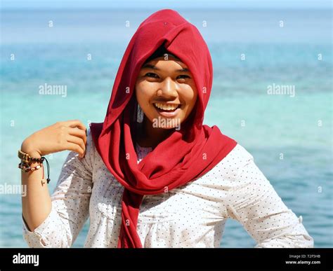 Laughing Indonesian Muslim Girl Wears A Stylish Maroon Coloured Hijab