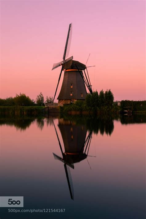 Windmill Of Kinderdijk And Its Reflection At Dusk Kinderdijk