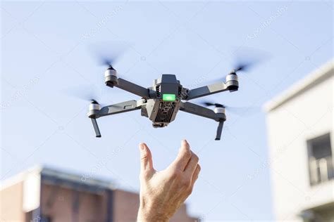 black drone lands   hands  technician stock photo