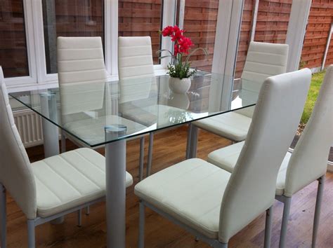 stunning glass dining table set     faux leather chairs white